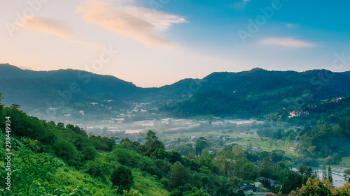 panorama of mountains with trees and clouds