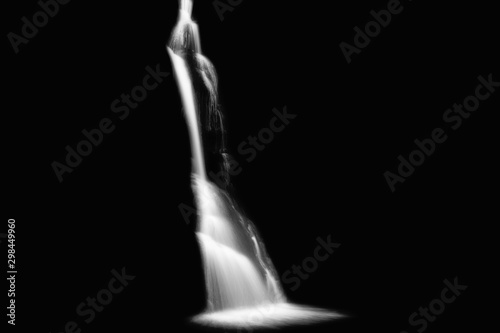 Long exposure of waterfall cascading over rocks, waterfall isolated on black background, Black and White Photo, Fraga da Pena, Portugal photo