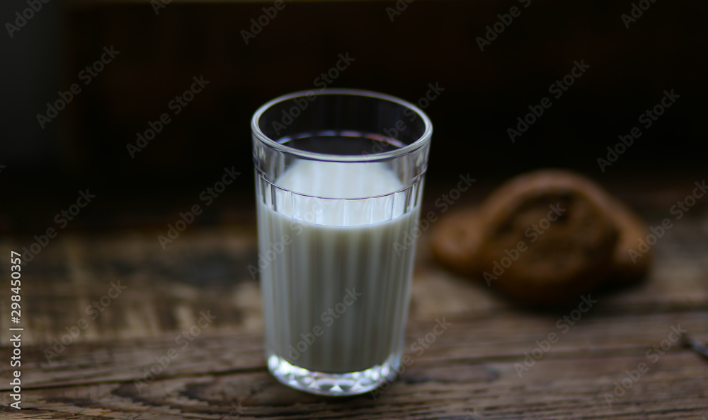 glass of milk cookies with chocolate chips on the background of wooden boards glass of milk cookies with chocolate chips on the background of wooden boards