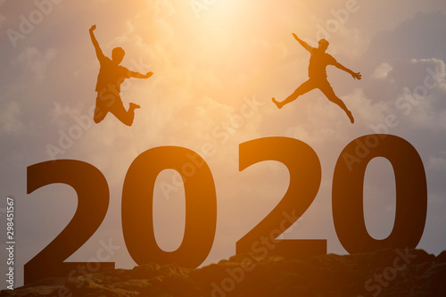 Concept Happy new year 2020 Silhouette image of happy man jump up to beautiful sky.