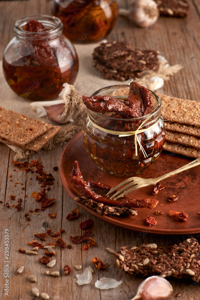 Sun-dried tomatoes with olive oil in a jar of rye bread and a chapel