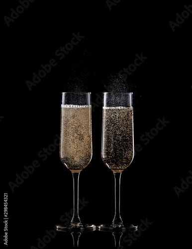 full champagne glasses on black background