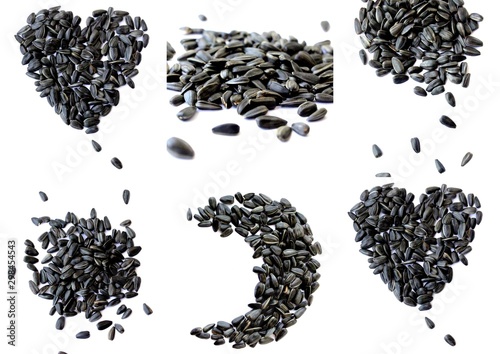 Black small sunflower seeds. Seeds in the shape of a heart and a month. Handful of seeds.