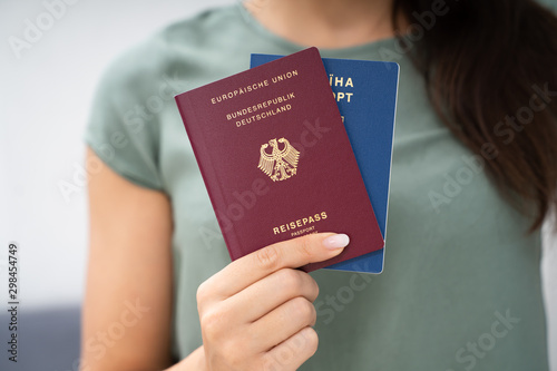 Woman Holding Two Passports photo