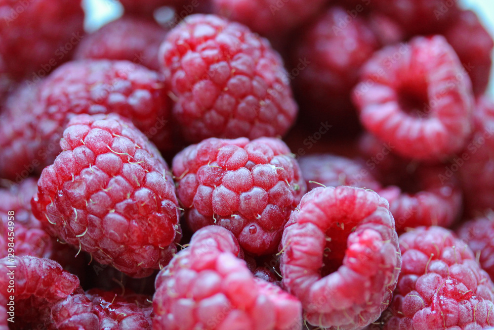 Background with fresh raspberry closeup. Raspberry macro photography with copy space. Healthy organic berries of bright red color. Template for banner, menu, food label, organic shop, garden Background with fresh raspberry closeup. Raspberry macro photography with copy space. Healthy organic berries of bright red color. Template for banner, menu, food label, organic shop, garden