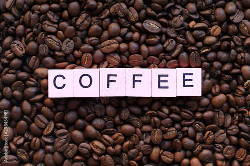 Coffee word on a background of coffee beans