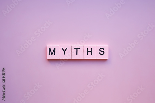 Myths word wooden cubes on pink background