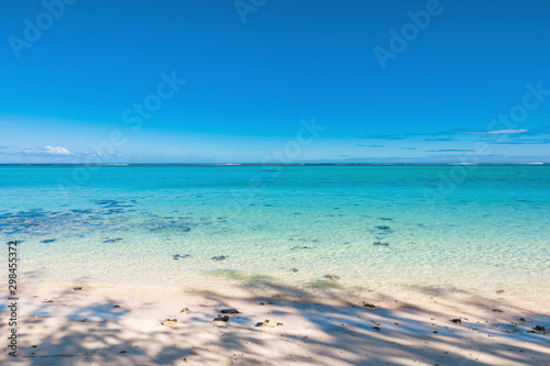 Tropical scenery - beautiful beach with transparent ocean and blue sky
