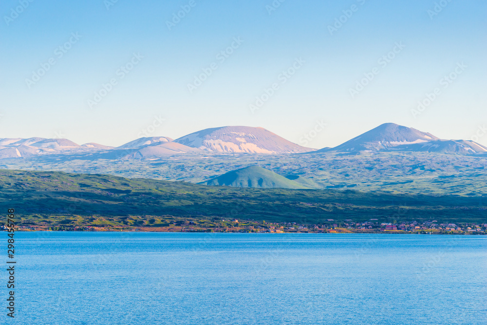 Lake with clear water Sevan and beautiful picturesque mountains of Armenia in summer season