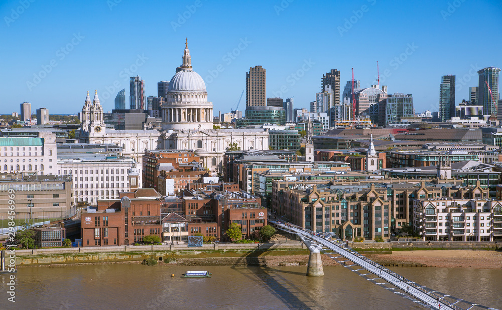 St. Paul's cathedral and City of London view including river Thames and Millennium bridge in early morning.