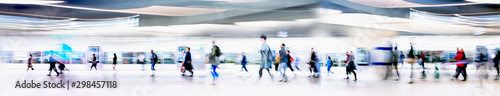 Lots of business people walking through big open space. People on the way to work, rushing via the underground tunnel. London, UK