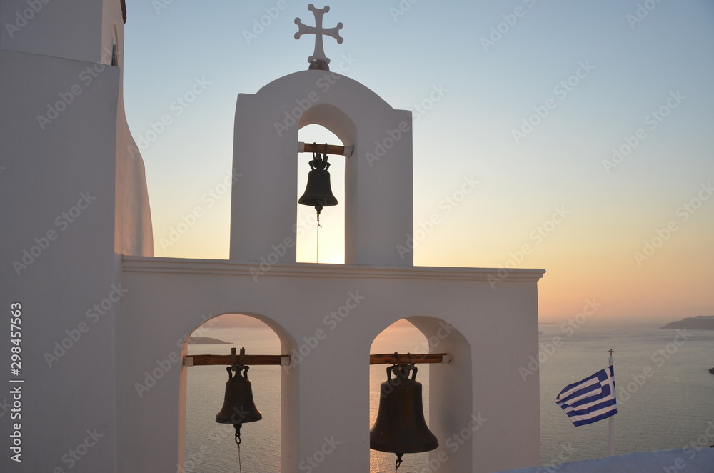Three bells of a cathedral in Santorini Greece with the sunset of the background. Three bells of a cathedral in Santorini Greece with the sunset of the background.