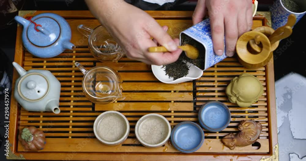 Chinese tea ceremony with puerh tea, Brewing black Shu Puer in pot from Ixin clay, boiling water pours into kettle, close up with