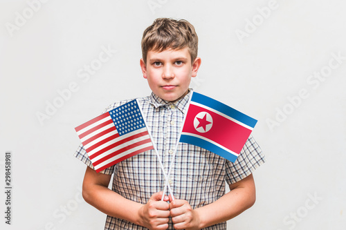 teen boy holds the flags of the