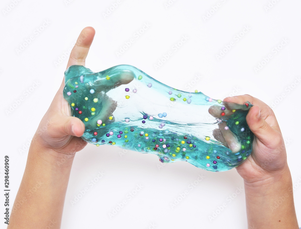 Blue slime in child hands on white background.