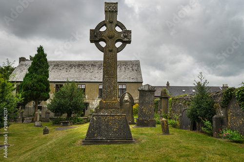 Cemetery with Celtic crosses in the city of Kilkenny in Ireland, with cloudy sky. photo