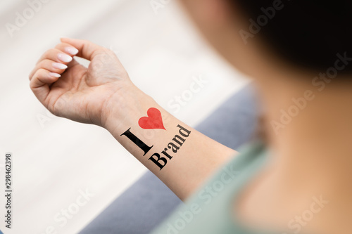 Woman Showing I Love Brand Tattoo photo