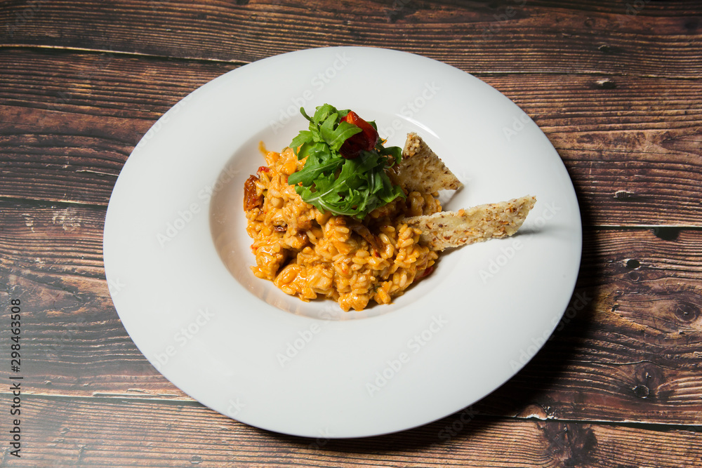 Risotto safran gamberi served on white plate