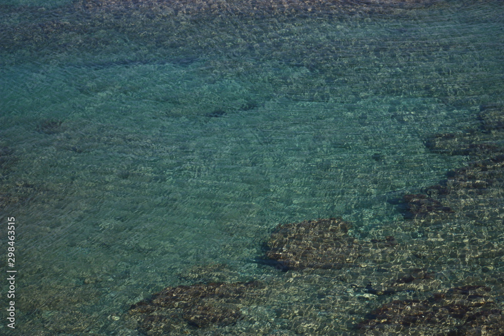 Rocks, sand, turquoise water and ripples, Crete, Mediterranean sea