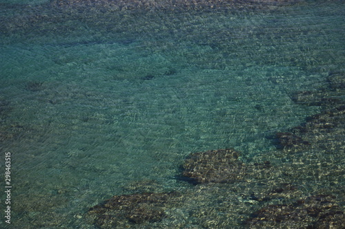 Fototapeta Naklejka Na Ścianę i Meble -  Rocks, sand, turquoise water and ripples, Crete, Mediterranean sea