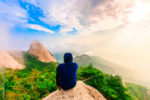 A man sitting on the mountain at Bukhansan National park, seoul, south korea photo
