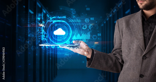 Hand holding tablet with cloud technology and dark concept