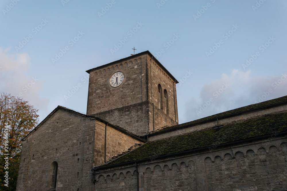 Tower with clock on an ancient romanesque church 