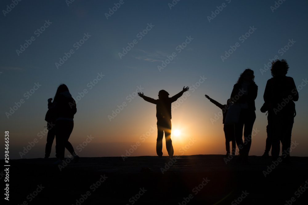 silhouettes of people on the sunset