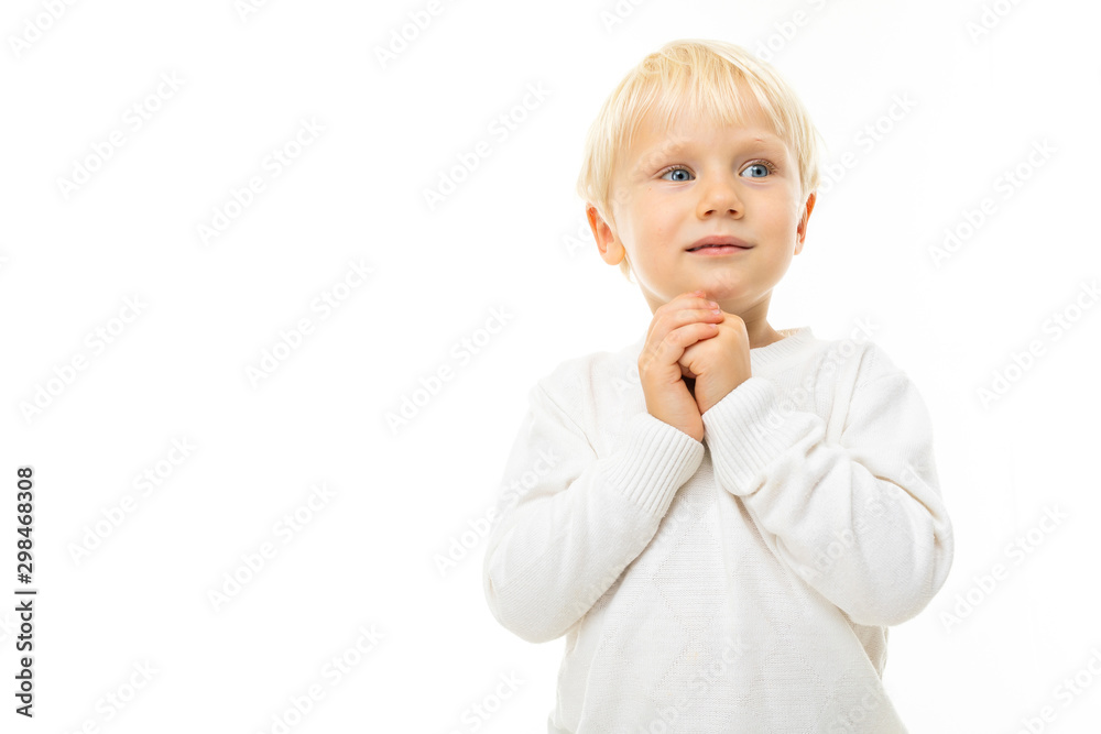 Little boy with short blonde hair, blue eyes, cute appearance, in white jacket, light blue pants, stands and quietly laid hands Little boy with short blonde hair, blue eyes, cute appearance, in white jacket, light blue pants, stands and quietly laid hands