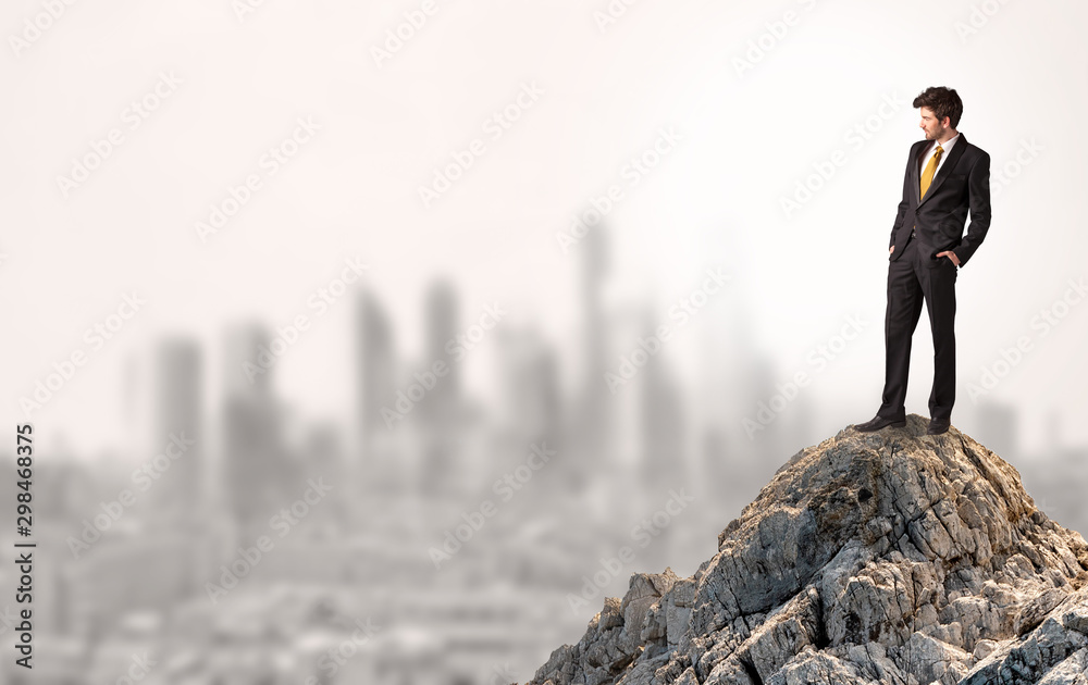 Young business person looking to the city from distance Young business person looking to the city from distance
