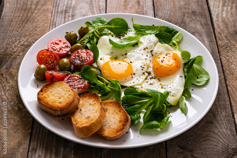 Breakfast - fried egg ,toasts and vegetabla salad Breakfast - fried egg ,toasts and vegetabla salad