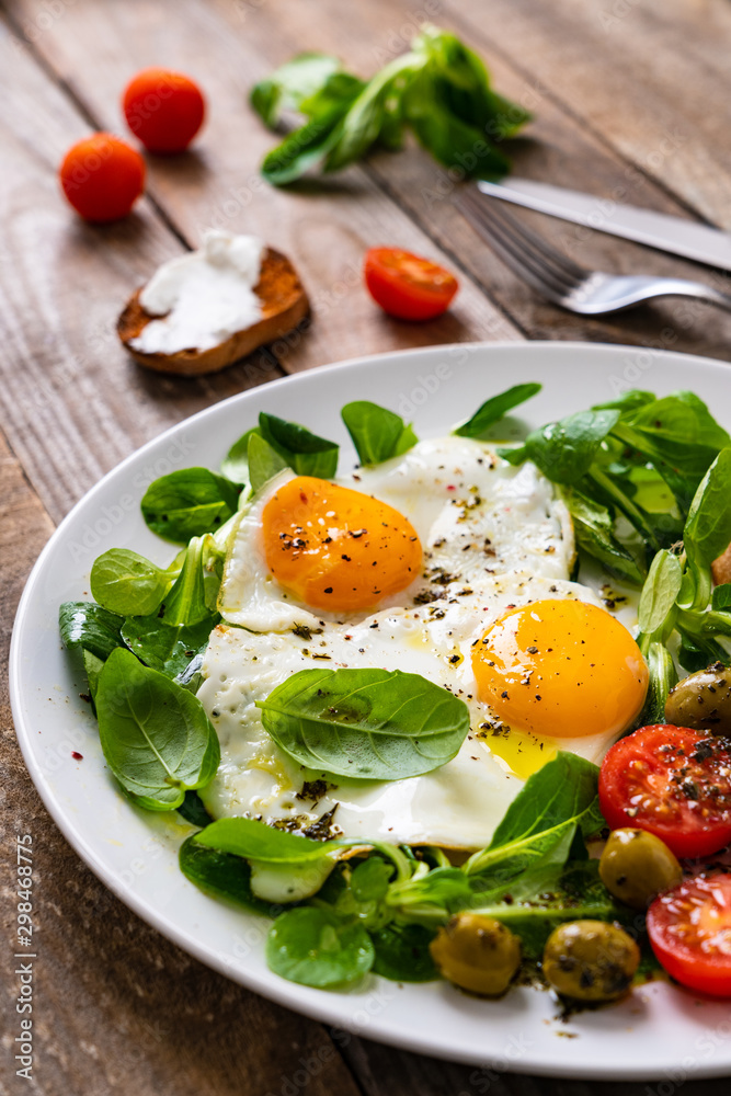 Breakfast - fried egg ,toasts and vegetabla salad Breakfast - fried egg ,toasts and vegetabla salad