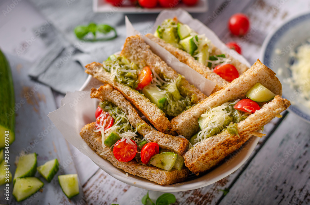 Healthy toast with vegetables, pesto and cheese
