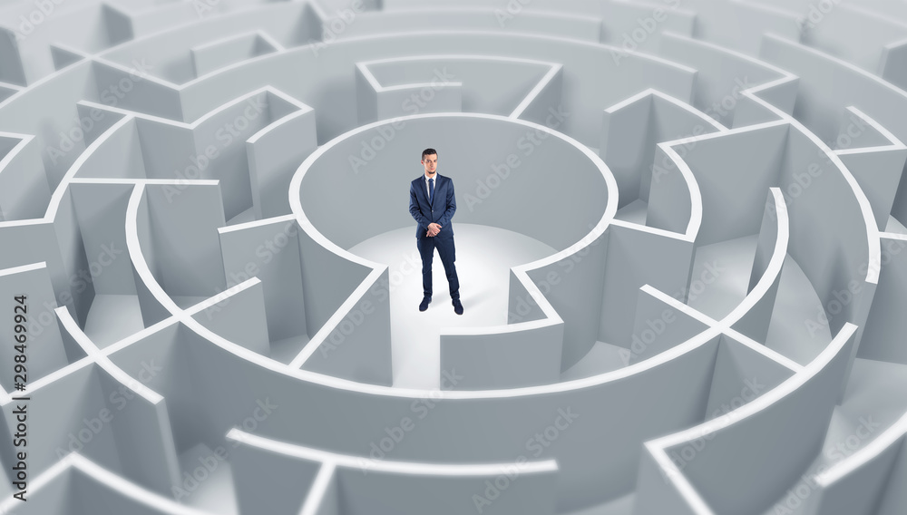 Young businessman standing in a middle of a 3d round maze Young businessman standing in a middle of a 3d round maze