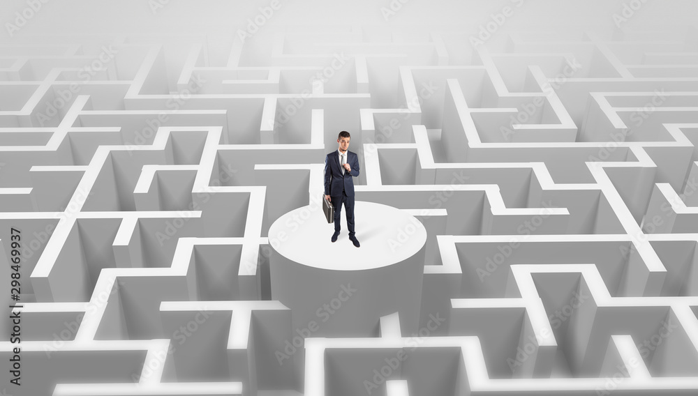 Businessman standing on the top a maze and looking through Businessman standing on the top a maze and looking through