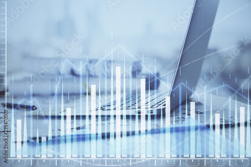 Stock market graph and table with computer background. Double exposure. Concept of financial analysis.