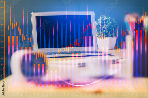 Financial chart drawing and table with computer on background. Multi exposure. Concept of international markets. © peshkova