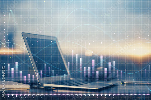 Financial graph colorful drawing and table with computer on background. Multi exposure. Concept of international markets.