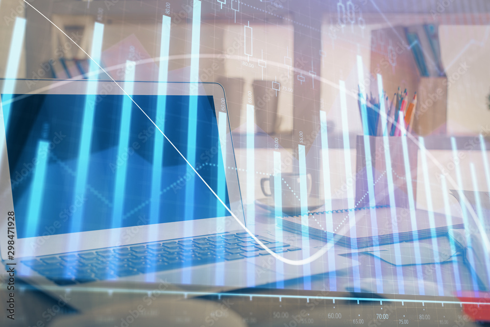 Stock market chart hologram drawn on personal computer background. Multi exposure. Concept of investment. Stock market chart hologram drawn on personal computer background. Multi exposure. Concept of investment.