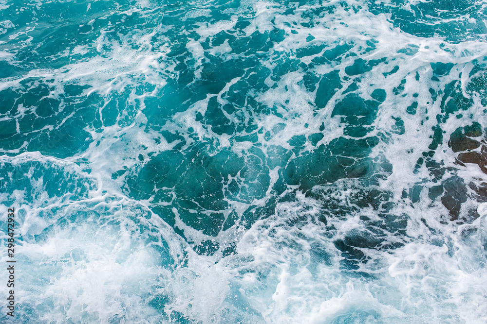 Turquoise sea surface background with splashing waves