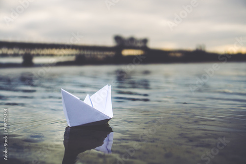 Paper boat floats in the river