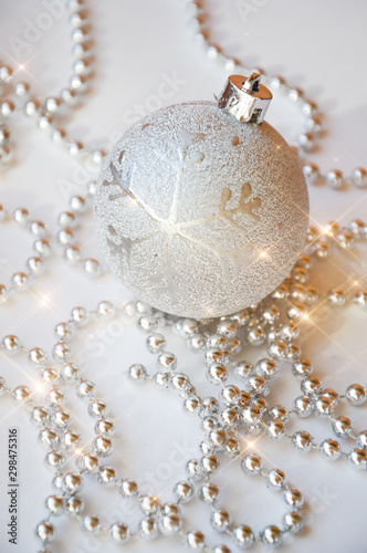 gray Christmas ball on the Christmas tree. shiny ball. metallic color. decorations for the holiday. New year, Christmas. grey beads for decoration. Holiday greeting card. Ball on white background.