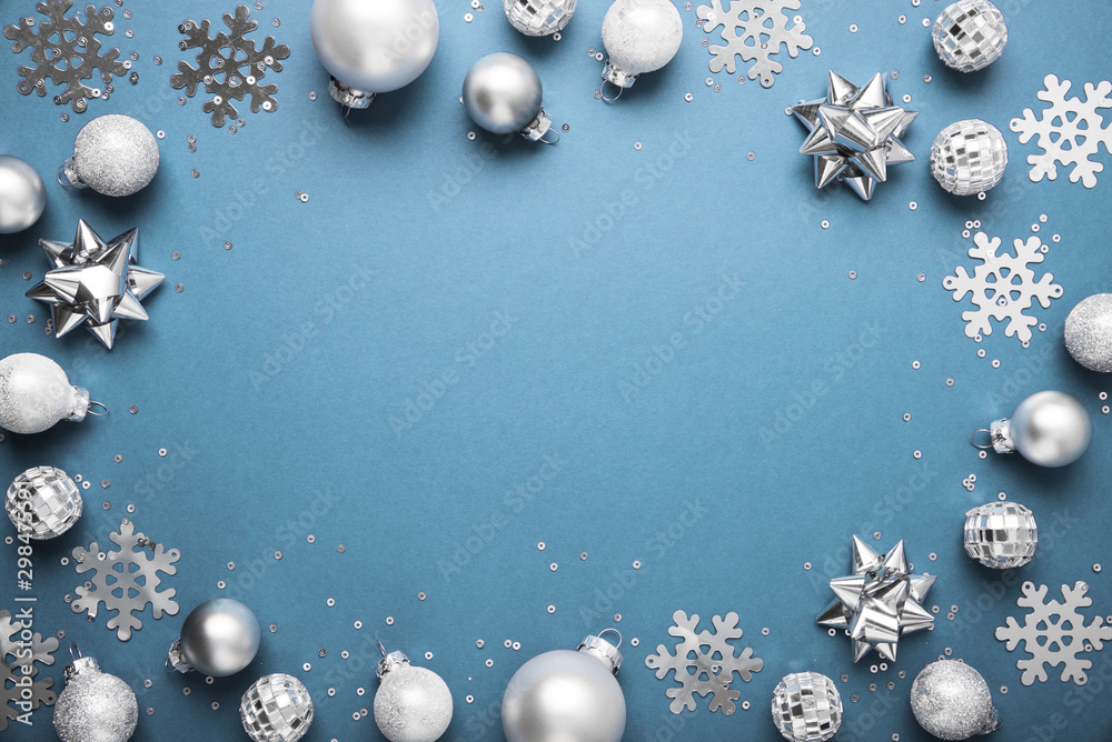 Merry Christmas and Happy Holidays greeting card, frame, banner. New Year. Noel. Christmas white, silver .ornaments on blue background top view. Winter xmas holiday theme. Flat lay Merry Christmas and Happy Holidays greeting card, frame, banner. New Year. Noel. Christmas white, silver .ornaments on blue background top view. Winter xmas holiday theme. Flat lay