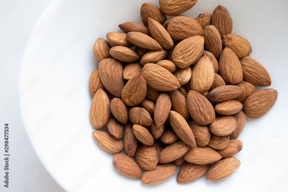 Almonds kernels on a white plate. Almonds kernels on a white plate.