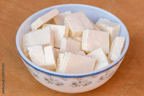 Paneer cottage cheese close up, slice pieces of homemade fresh white raw panner cheese.