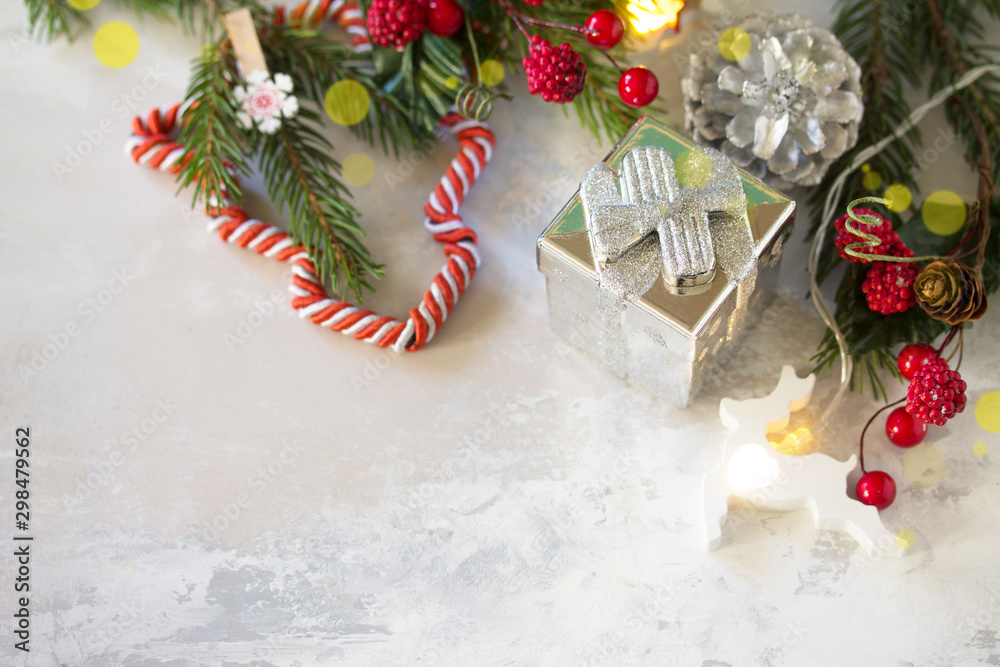 Fototapeta premium Christmas and New Year holidays composition with fir branches, gifts and new year's garland. Free space for your text.