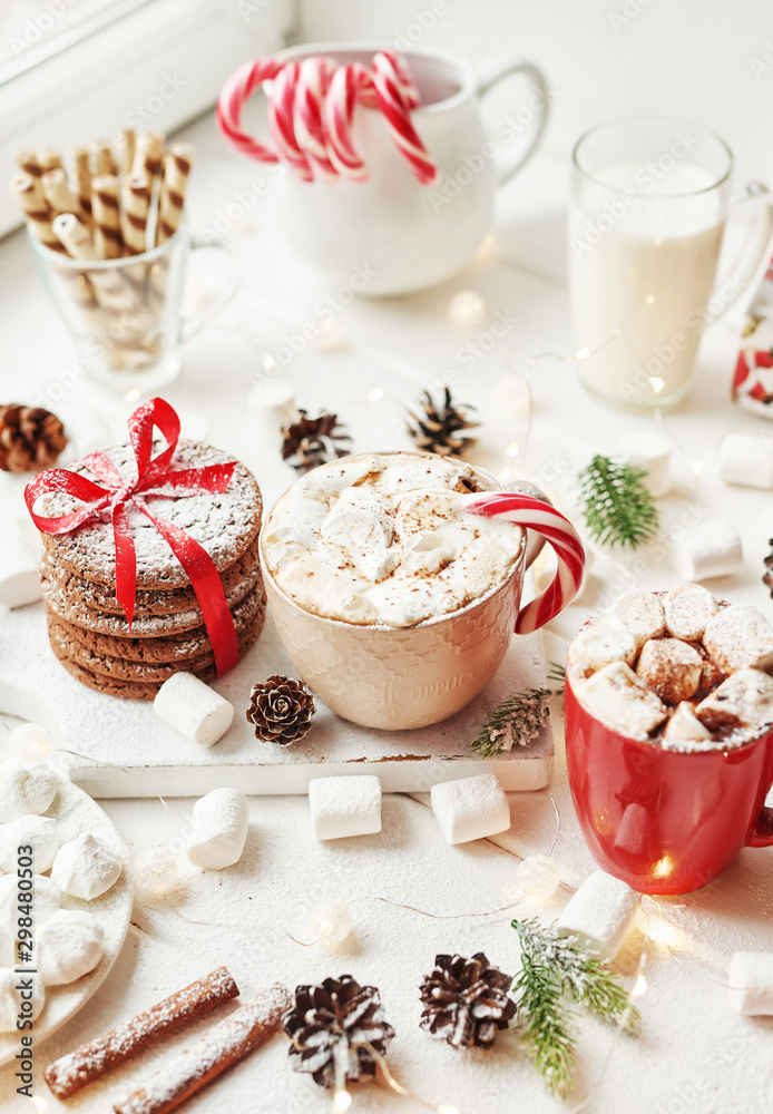 Christmas cookies, milk, cocoa, marshmallows, candies on a white plate by the window Christmas cookies, milk, cocoa, marshmallows, candies on a white plate by the window