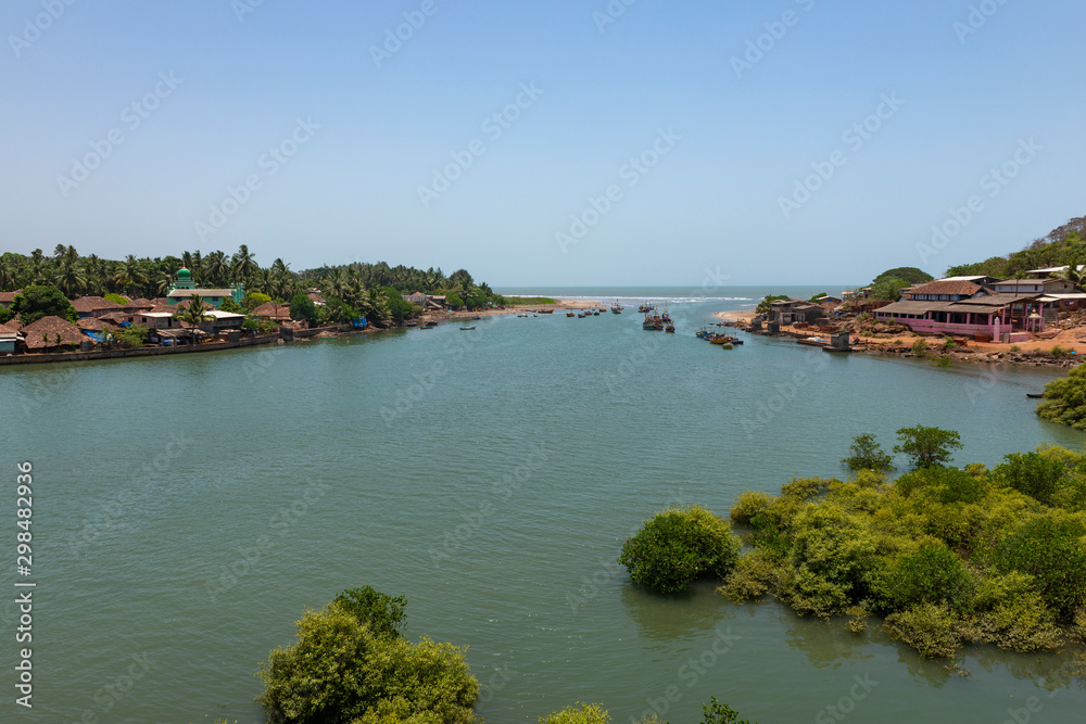River meeting sea near Kelshi in Raigad district,maharashtra,India River meeting sea near Kelshi in Raigad district,maharashtra,India