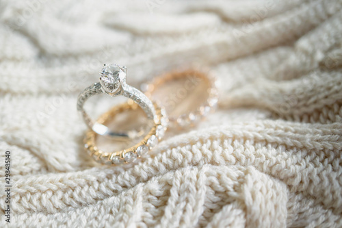 Close up of diamond ring on sweater. (soft and selective focus) love and wedding concept.