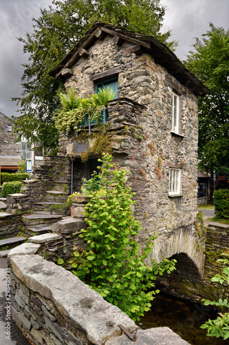 17th Century stone Bridge House straddling Stock Beck in the village of Ambleside Cumbria England Lake District National Park